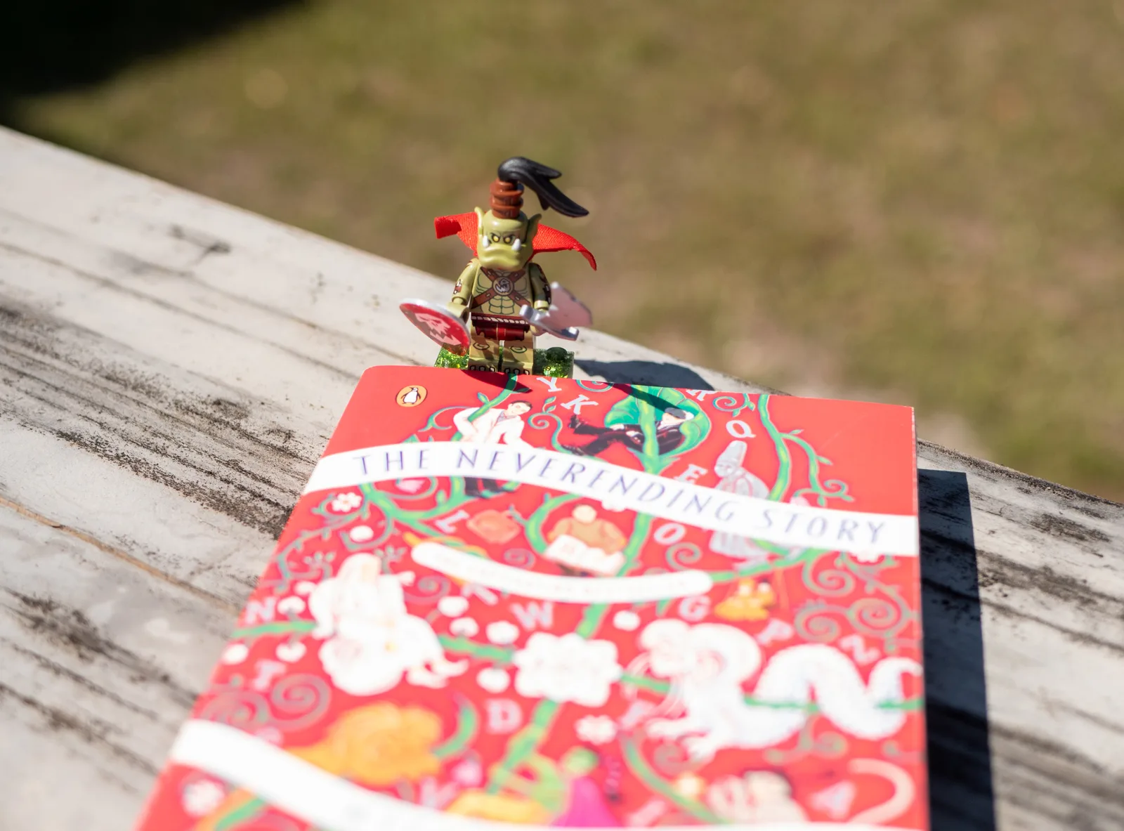 A minifigure bookmark sitting on top of a copy of The Neverending Story